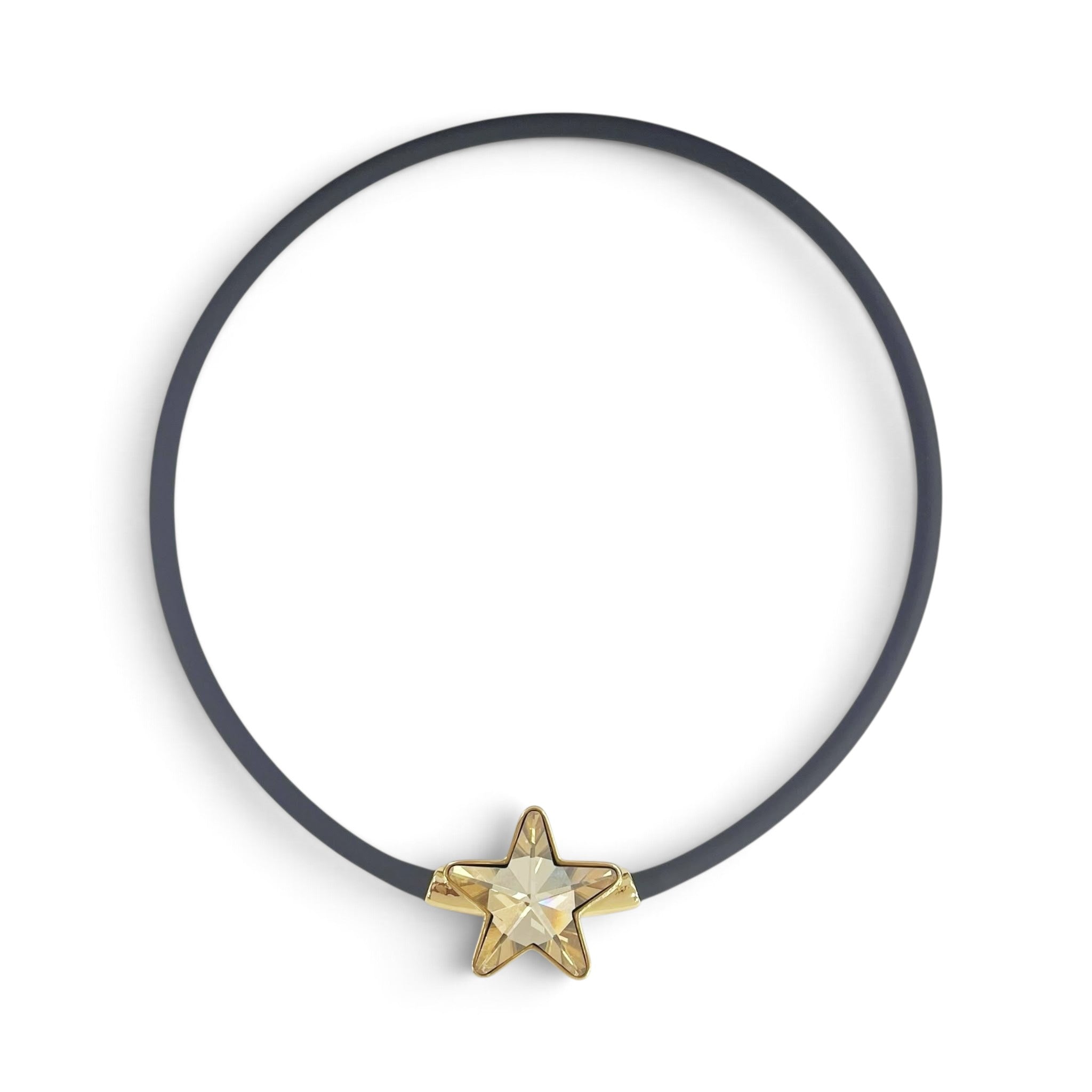 X5 Bijoux black rubber choker necklace featuring a gold-toned star pendant with a sparkling champagne crystal center.